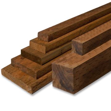An image of stacked pressure treated lumber in multiple dimensions